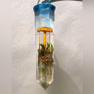 Small mushroom and moss agate in a resin crystal pendant
